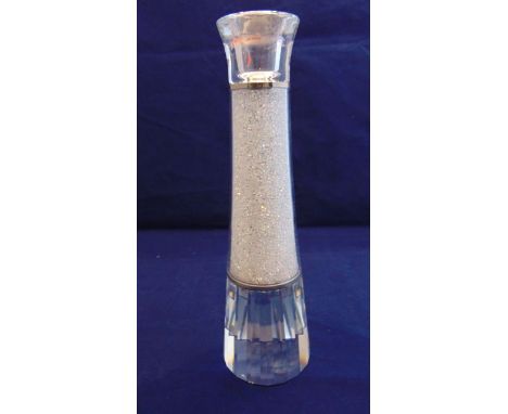 A contemporary Swarovski crystal candlestick with metallic collars, facetted base and crystal filled finish, complete with or