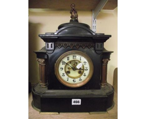 A mid-Victorian black slate and brass mounted mantel clock in a classical style with ionic supports and 8-day striking moveme