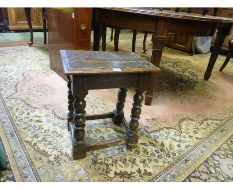 An Old English oak joint stool on bobbin turned supports