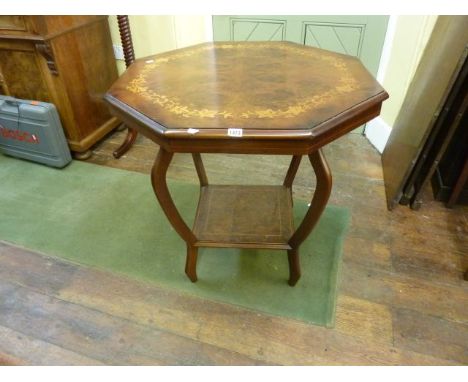 An Edwardian occasional table, the octagonal top with trailing ivy leaf detail on four shaped supports with under gallery, 82