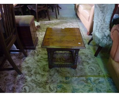 An old English style oak occasional table of square cut form on bobbin moulded supports and rails