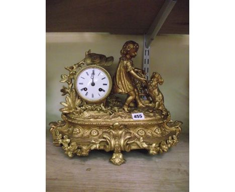 A 19th century gilded spelter mantel clock, the 8-day striking movement surmounted by a young child playing with a hound