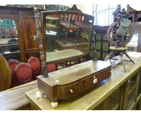 A 19th century rosewood toilet mirror, the box base fitted with three drawers with string inlay detail raised on ivory ball f