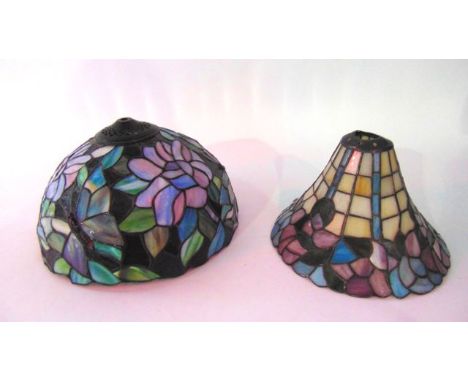 A leaded glass ceiling light shade constructed from stained glass panels depicting butterflies amongst foliage, loosely in th