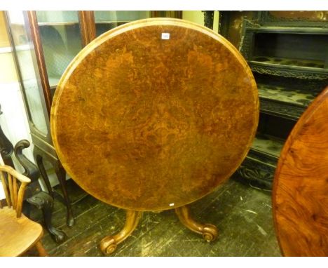 A good quality Victorian walnut and burr walnut snap top tea table, 104 cm diameter, raised on a carved column and tripod bas