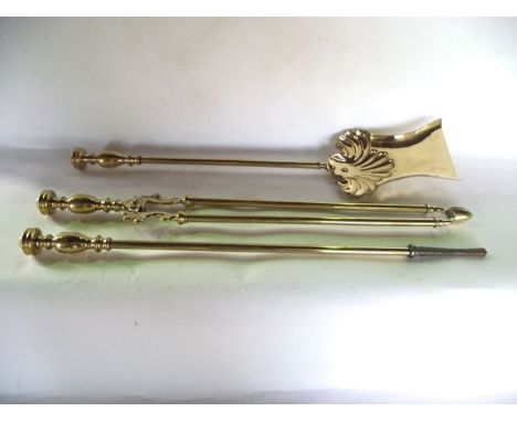 A good quality late 19th century brass fireside trio to include trowel with shaped blade, poker and tongs, 63 cm long approx