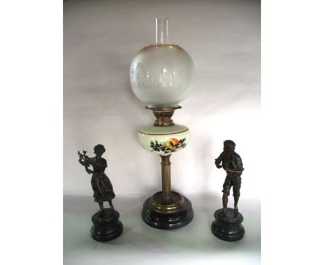 An oil burning lamp raised on a brass fluted column support set beneath an opaque glass fount with painted silhouette bird an