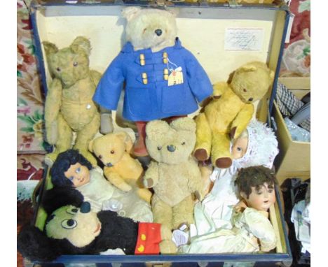 A vintage banded travelling trunk containing a quantity of vintage dolls and teddy bears to include a Paddington Bear by Gabr