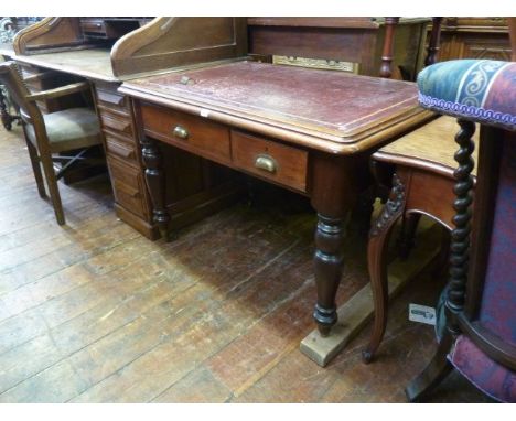 A Victorian mahogany writing table with inset maroon leather top over two frieze drawers of graduated size with velvet slide 