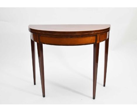 A George III mahogany and satinwood, demi-lune card table, inlaid with rosewood crossbanding and boxwood stringing, on square