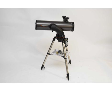 A Celestron Nexstar 130SLT refracting telescope, on tripod stand with remote control keypad, instructions and paperwork.Condi