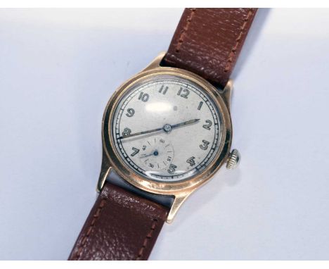 A 9ct gold wristwatch, the white dial with Arabic numerals and subsidiary seconds dial, manual wind, with leather strap