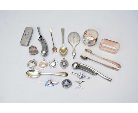 A small collection of silver to include two napkin rings, a miniature hand mirror, oyster fork, five silver fobs, an ARP badg