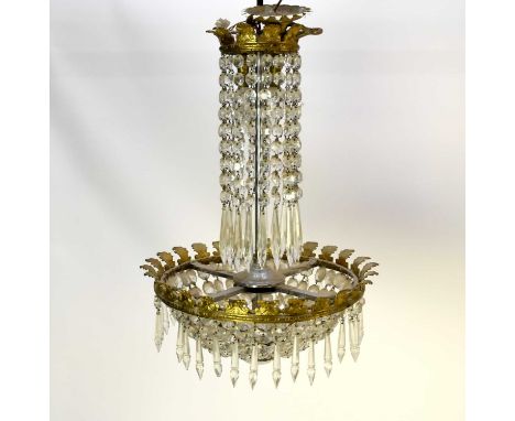 An Empire style beaded chandelier, foliate cast with pendant faceted droplets around a central stem above a four-light ring w