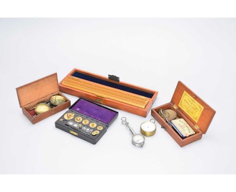 An assembled group of scientific collectables: a brass pocket barometer by Field, Birmingham, two cased apothecary scales, a 