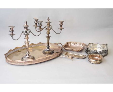 A collection of silver plated wares, comprising; a large oval gallery tray, a pair of candelabra, two circular salvers, an ov