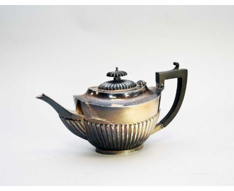 An early 20th century silver teapot, Alexander Clark &amp; Co Ltd, Birmingham 1915, of oval half reeded form with ebonised ha