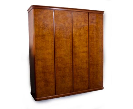 A BURR WOOD VENEERED ART DECO STYLE FOUR DOOR WARDROBE fitted with hanging space and drawers within, 214cm x 65cm x 230cm