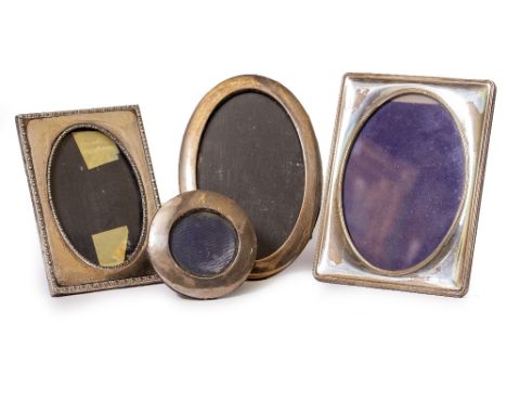 FOUR VINTAGE SILVER PHOTOFRAMES  to include two circular examples and two rectangular examples, the largest 21cm high (4)