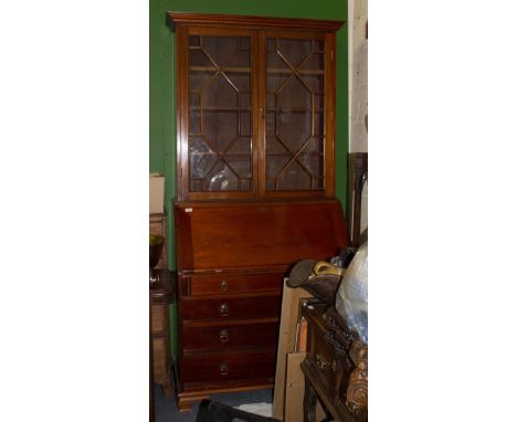 A MAHOGANY BUREAU BOOKCASE the interior with six drawers and two pigeon holes, and a green leather inset fall front over four