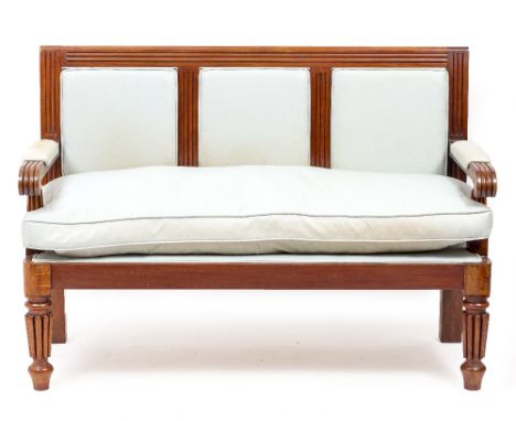 A 19TH CENTURY MAHOGANY SETTLE  or bench, upholstered back arms and seat and standing on reeded front legs 139cm wide x 98cm 