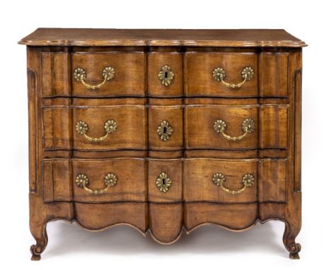AN 18TH CENTURY FRENCH PROVINCIAL WALNUT SERPENTINE CHEST OF THREE DRAWERS having brass handles and scrolling feet, 107cm wid