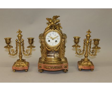 A GOOD SMALL 19TH CENTURY FRENCH ORMOLU AND PINK MARBLE THREE PIECE CLOCK SET, the eight day movement with dial painted with 