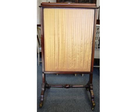 A 19TH CENTURY MAHOGANY FIRE SCREEN with adjustable silk-work panels.