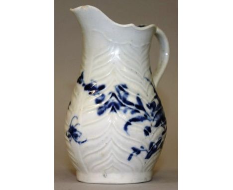 A RARE WORCESTER BLUE AND WHITE JUG with raised chevron design and blue flowers.  Workman’s mark in blue 3.75ins high.