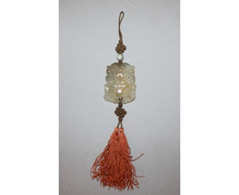 A GOOD 19TH/20TH CENTURY CHINESE PIERCED AND CARVED CELADON JADE PENDANT, with tassel attachments, the jade in the form of tw