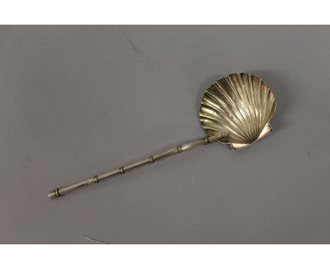 A CHINESE SILVER SPOON with shell bowl and bamboo type handle.