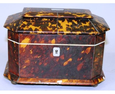 A REGENCY TORTOISESHELL TWO DIVISION TEA CADDY with cut off corners, ivory frame, supported on four metal wooden feet 7ins wi