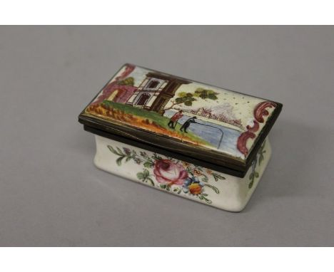 A RECTANGULAR ENAMEL SNUFF BOX AND COVER painted with a Lakeland scene and flowers to the sides 2.5ins wide.