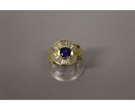 A DIAMOND AND SAPPHIRE SET GOLD RING.