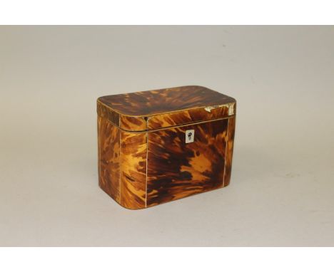 A REGENCY TORTOISESHELL TWO DIVISION TEA CADDY with moulded sides and boxwood frame 6.25ins wide.