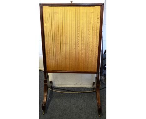 A REGENCY MAHOGANY FIRE SCREEN with silk-work panels.