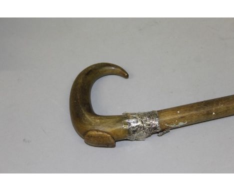 A CURVING RHINO WALKING STICK. 32ins long 475gms. Note: An export licence cannot be obtained for this item under current legi