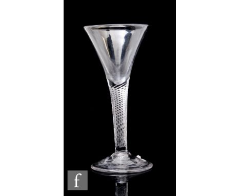 An 18th Century drinking glass, circa 1740, the drawn trumpet bowl above an air twist stem, raised to a conical foot, height 