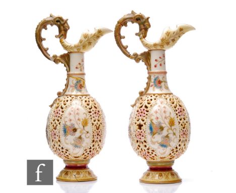 A pair of Zsolnay Pecs reticulated ewers, circa 1900, of globe and shaft form and boat shaped spout and moulded serpent handl