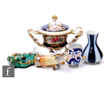 A Korosten Russian porcelain twin handled cup with double side relief moulded portrait decoration, height 8.5cm, together wit