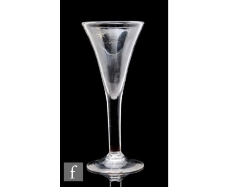 An 18th Century drinking glass circa 1740, the drawn trumpet bowl above a plain stem and raised to a conical foot, height 20.