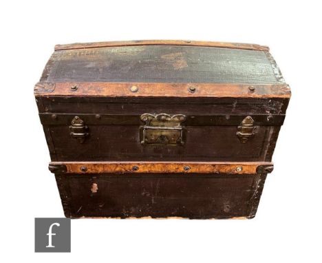 An Edwardian leather covered and wooden bound domed top two handled trunk, width 57cm.