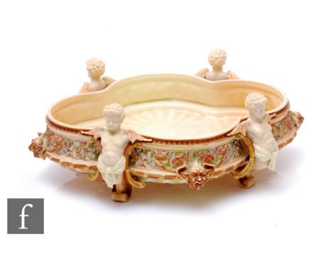 A Royal Worcester centrepiece, circa 1890, of ogee form on four figural supports modelled as winged putti, the flower and lea