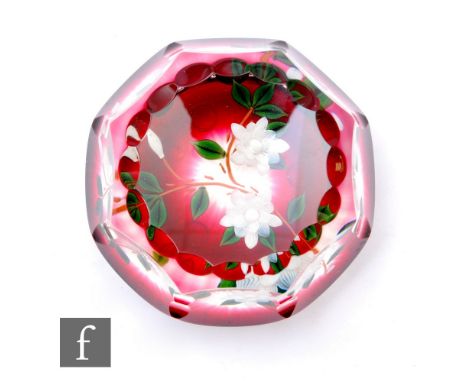 A contemporary William Manson glass paperweight, internally decorated with two stylised white lamp work flowers and bud with 