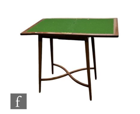 An Edwardian crossbanded mahogany rectangular fold over card table, the green baize top on square tapering legs united by swe