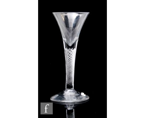 An 18th Century drinking glass, circa 1750, the drawn trumpet bowl above an air twist stem, raised to a conical foot, height 