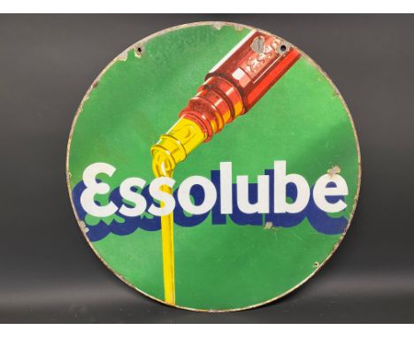 An Essolube circular double sided enamel sign with image of oil pouring from a bottle, 26" diameter.