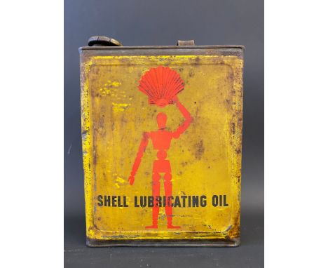 A Shell Lubricating Oil rectangular gallon can with robot/stick man motifs.