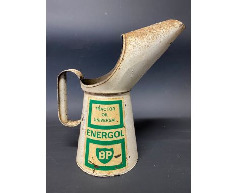A BP Energol Universal Tractor Oil quart measure in good condition.