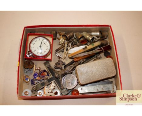 A tray box containing silver bladed and mother of pearl pen knife; various thimbles; a pocket watch; crucifix etc.